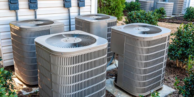 Four air conditioner units outside of house